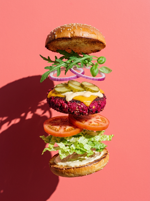 AI product photography scene — food deconstructed beet burger floating pink | rawbit AI product photography scene — food deconstructed beet burger floating pink | rawbit